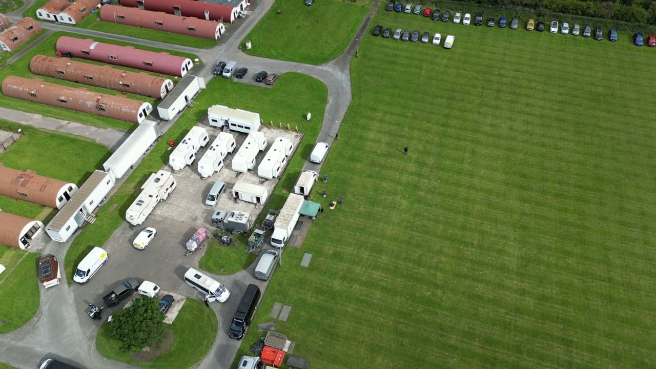 Aerial view of the motorhome aire area at Cultybraggan Camp with the Perthshire landscape around the estate
